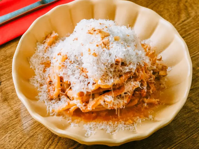 Pasta in meat ragù topped with grated parmesan